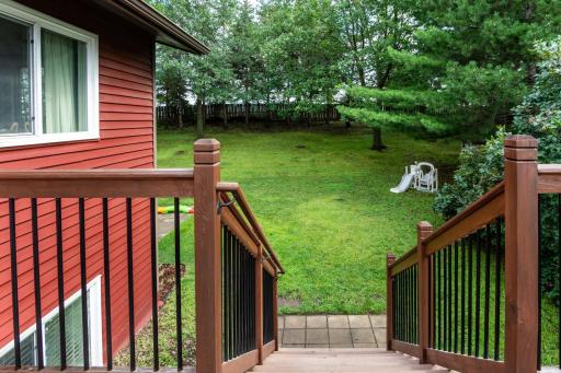 A stair landing leads to the fully-fenced backyard.