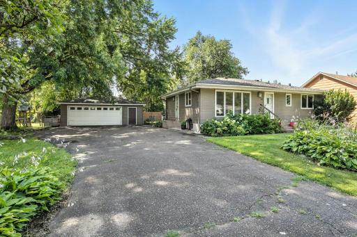 Oversized two-car detached garage with extra storage space and a separate entry door. Ample driveway space provides plenty of room for vehicles, trailers, or guests.
