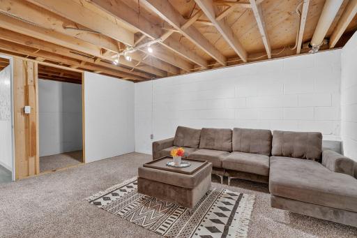 The lower level family room is ready for your vision, already framed for a closet and with the addition of an egress window, it can easily be converted into a 6th bedroom.