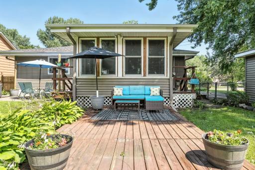 The fully fenced backyard offers two spacious patios just off the sunroom, creating the perfect setting for grilling, dining, and entertaining.
