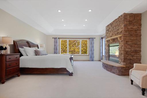 While you are upstairs don't miss the massive, sun filled primary bedroom with views of the water from every window! Featuring another stunning floor to ceiling stone gas fireplace!