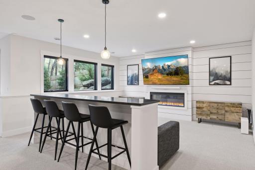 Lower level family room with gas fireplace and built-in snack bar