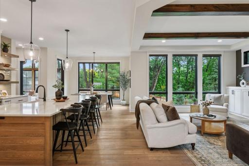 Open floor plan with warm beams, electronic custom blinds