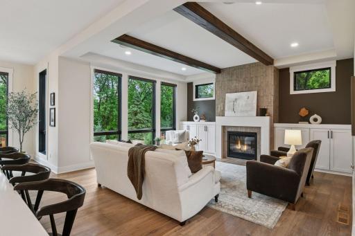 Floor to ceiling windows with light pouring into the home harmonizing the outside with the inside