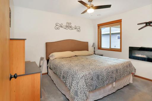 Second bedroom with ceiling fan and electric fireplace..jpg