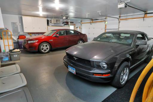 Huge heated garage with room for 3 vehicles and cabinet, storage space..jpg