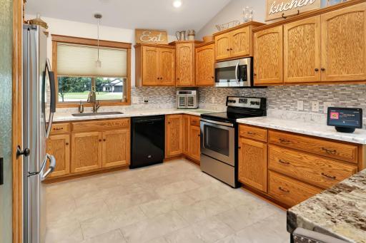 Spacious and upgraded kitchen with new countertops, sink, microwave and fridge..jpg