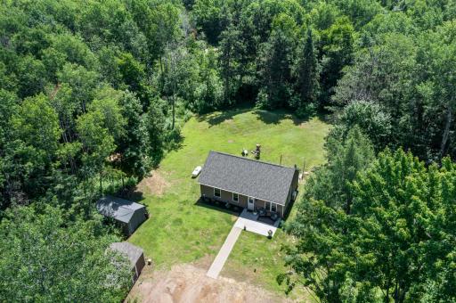 Areal view of maintained yard surrounded by gorgeous dense trees and foliage