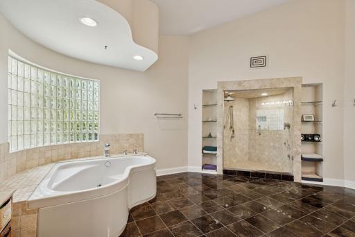 The Primary Bathroom offers tiled flooring, a jetted bathtub and spacious tiled steam shower.