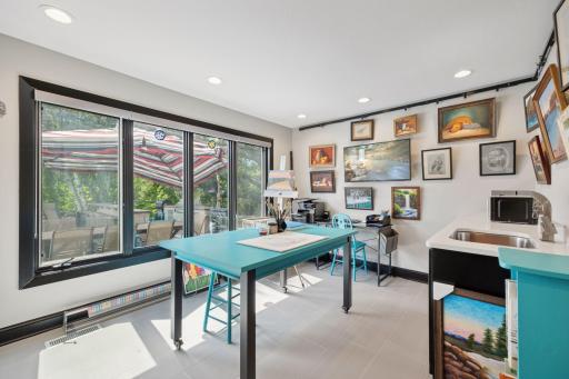 Tucked away behind glass French Doors is the Hobby or Craft Room - south-facing windows fill the space with natural light.