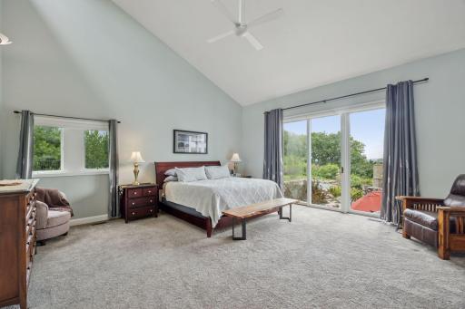 Tucked away on the main level is the private Primary Suite - the 18-foot vaulted ceiling features transom windows that bring in natural light to this private retreat.