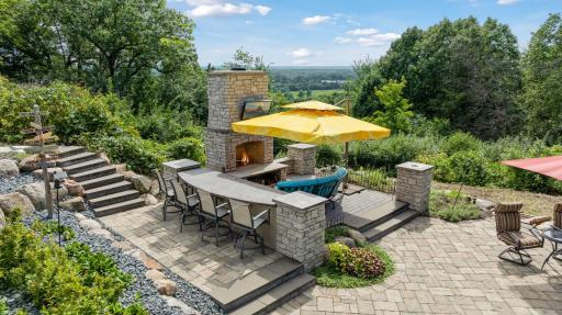 Custom designed by Southview Designs, the outdoor living room offers a wood burning fireplace and built-in bar with beverage refrigerator. Check out the amazing views to the south!
