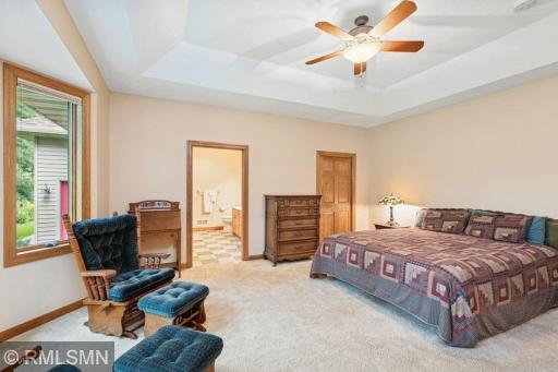 Primary bedroom with full bath, large walk in closet, and access to the backyard screened in porch