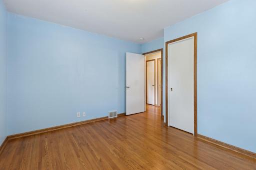 Two bedrooms located side by side on the main floor, with a full bath in-between. Primary bedroom located a few steps around the corner.