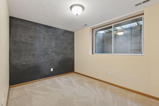 Lower level fourth bedroom with egress window and closet.