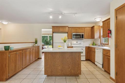 Excellent kitchen storage with custom oak cabinets, and breakfast bar seating at the center island.
