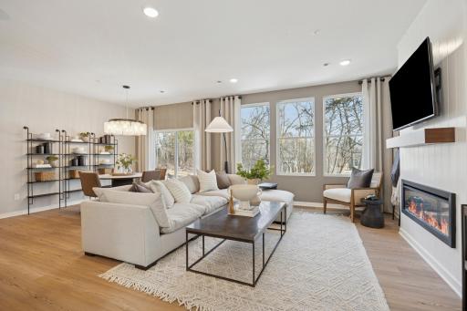 Soaring windows provide a striking view in the home and drench the main level in sunlight! Photo of Model Home.