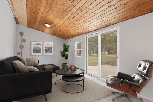 Additional Bonus Room with vaulted ceilings off garage with access to back yard and lower level (virtually staged photo)