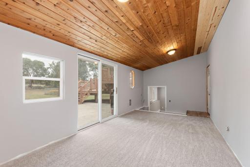 Additional Bonus Room with vaulted ceilings off garage with access to back yard and lower level