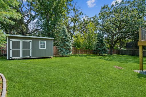 Fully fenced backyard with a shed for bonus storage space!