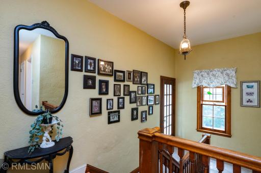Notice the beautiful authentic ceiling fixture above the hall and staircase.
