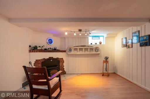 Fun and versatile lower level family room presents the second fireplace (wood-burning).