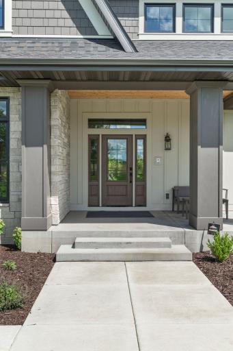 Large, welcoming cement front porch entrance