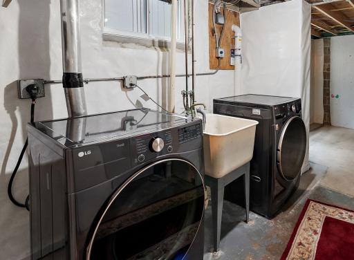 Basement laundry room. Note the radon mitigation system in the corner for peace of mind.