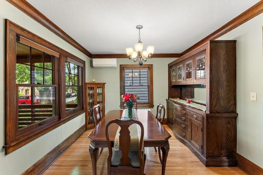 Formal dining room with an antique buffet, salvaged in all its historic glory (leaded glass with splashes of color) repurposed to perfectly accent a space calling out for family dinners, card games with friends, or holiday hosting.