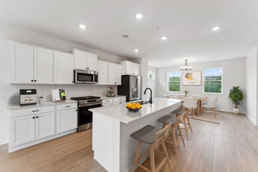 Light and bright! The kitchen has timeless finishes that blend an elevated feel and functionality. Photo of similar home.