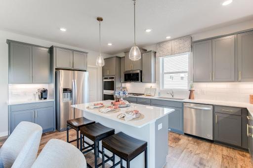 The open layout provides an optimal area to cook and entertain. Envision gathering together in the heart of this home. *Pictures are of model home; actual colors may vary.