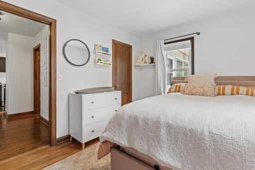 Bedroom two has two windows and hardwood floors
