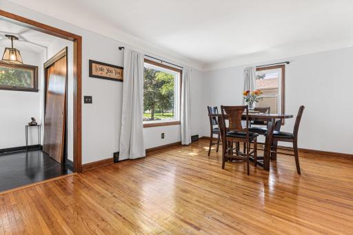 Entrywa with new flooring leads into dining room with bright picture window