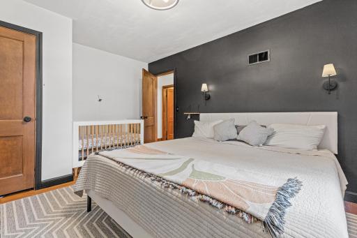Large bedroom one with natural hardwood floors
