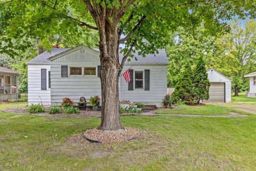 Front of home on Main Street with mature trees.