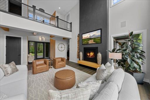 View of front entrance into Main Living Room and Open upper hallway to upper bedrooms on each end