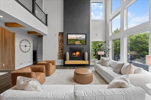 Stunning Gas fireplace and expansive windows looking onto the deck and private back yard creating luxury and warmth; providing nature's best art work