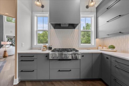 6 burner gas range flanked by outdoor views and lighting for task and style