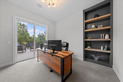 Main Level den or office with access to the deck makes this space great for day to day work hours or just reading enjoyment and individual office needs.
