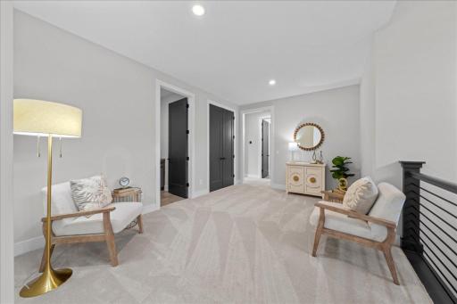 Moving up to the second level is this amazing sitting/study/office area. Behind the mirror is the electrical outlet for TV if needed. Just off this room is the upper laundry and a closet