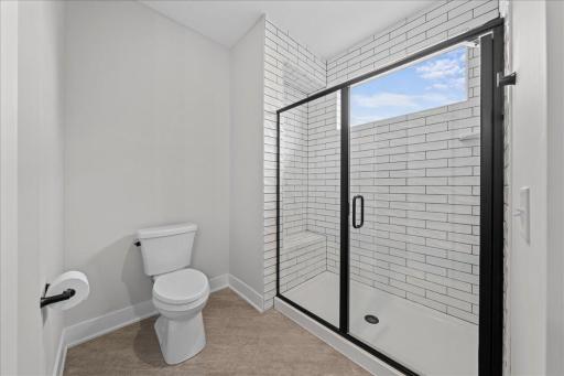 A Shower with natural light and built in bench; nice amenities!
