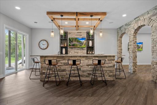 Large Bar with Refrigerator, Wine cooler, dishwasher and all the space needed for entertaining. The mix of materials make this space interesting- you want to spend time here