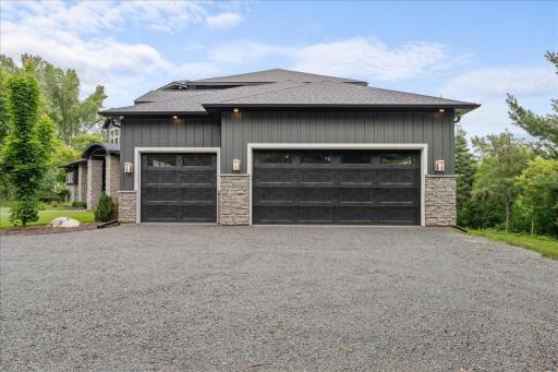 Luxury 3 car garage. Heated, Epoxy floor with drain and 2 EV charging stations.