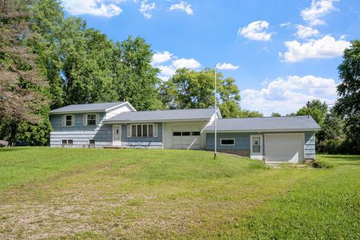 Set back from the street, the home's front elevation is framed by a spacious lawn and established trees.