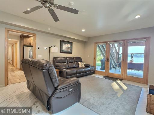 The lower-level family room is ideal for coming in straight from the lake, with easy access through the patio door. The ceramic tile flooring, designed to look like distressed wood, features a fun angular pattern that adds character to the space.