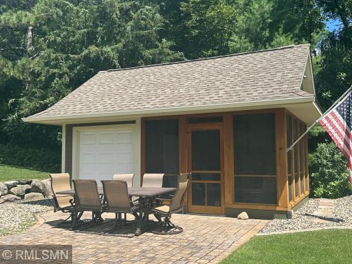 The lakeside boathouse is the perfect place to the paver brick patio while taking in the lake activity, or retreat to the screened-in interior for a bug-free escape. A portion of the boathouse offers extra storage, ideal for stowing lake toys.