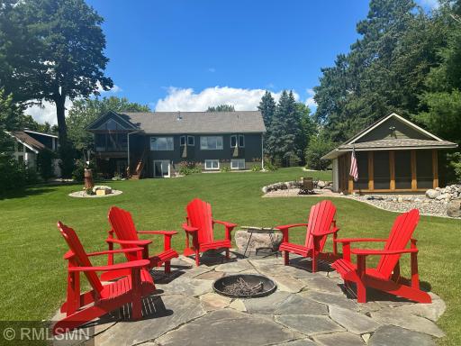 A sweeping view showcases the beauty of the lakeside yard.