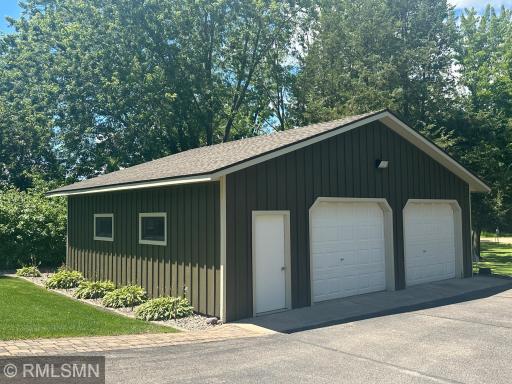 An oversized 32' x 28' detached garage offers flexible storage for vehicles, boats, or outdoor gear, plus potential for a workshop. A paver brick pathway welcomes you to the entrance, with a concrete floor and apron for lasting functionality.