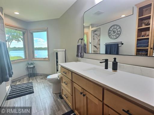The private primary 3/4 bathroom has been recently updated, featuring beautiful tile flooring and quartz countertops that create a luxurious ambiance.