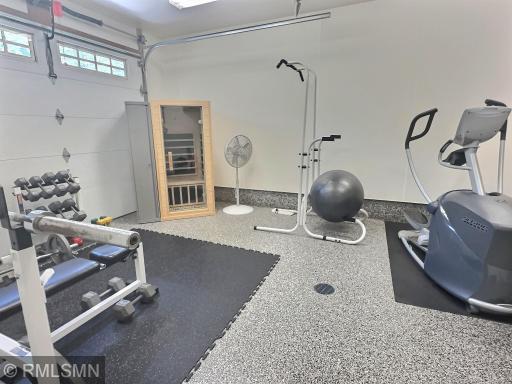 The third stall of the attached three-car garage is currently set up as a home gym, featuring aggregate flooring with a drain. The garage is also insulated and heated with in-floor heat.